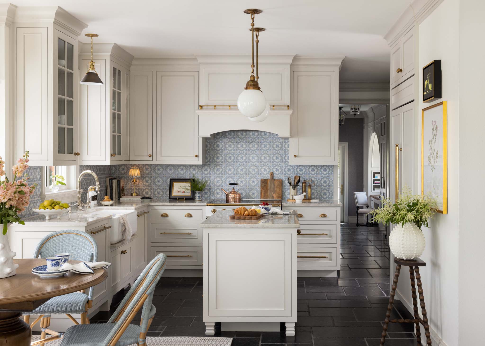 English country kitchen with custom inset cabinetry, brass hardware and blue tile backsplash