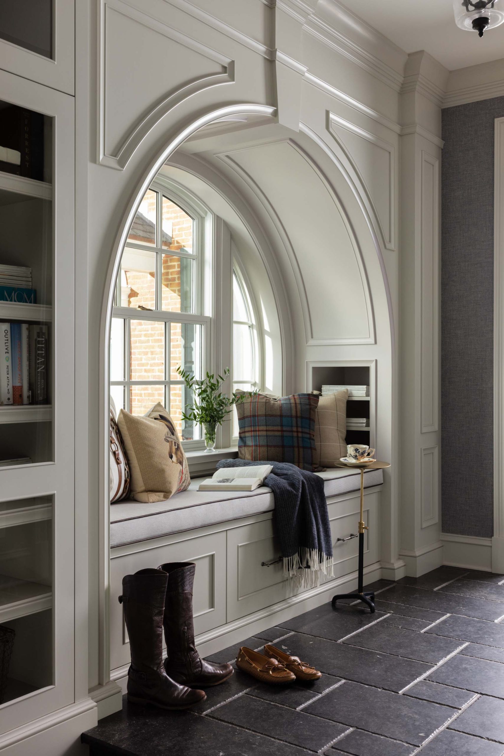 Traditional English mudroom with arched window seat and built-in storage