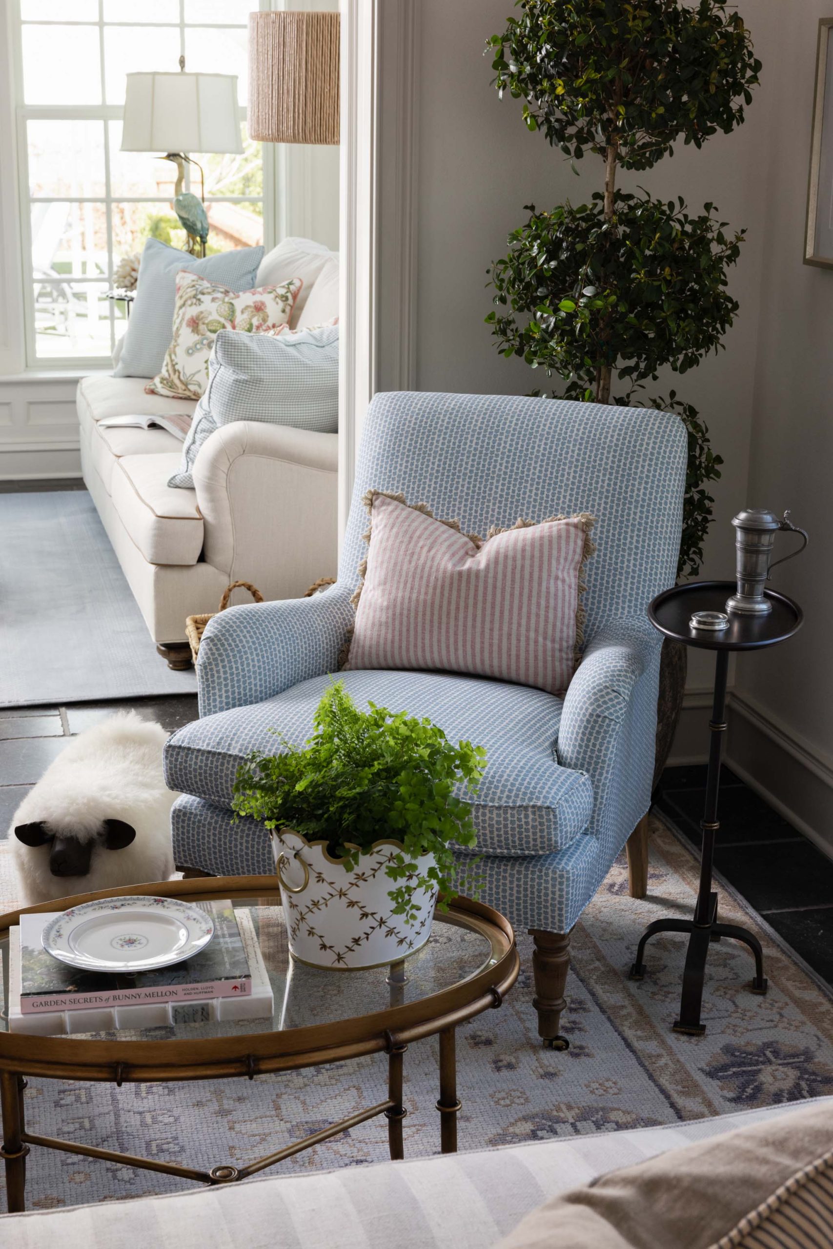 English country living room with custom blue upholstery and antique furnishings