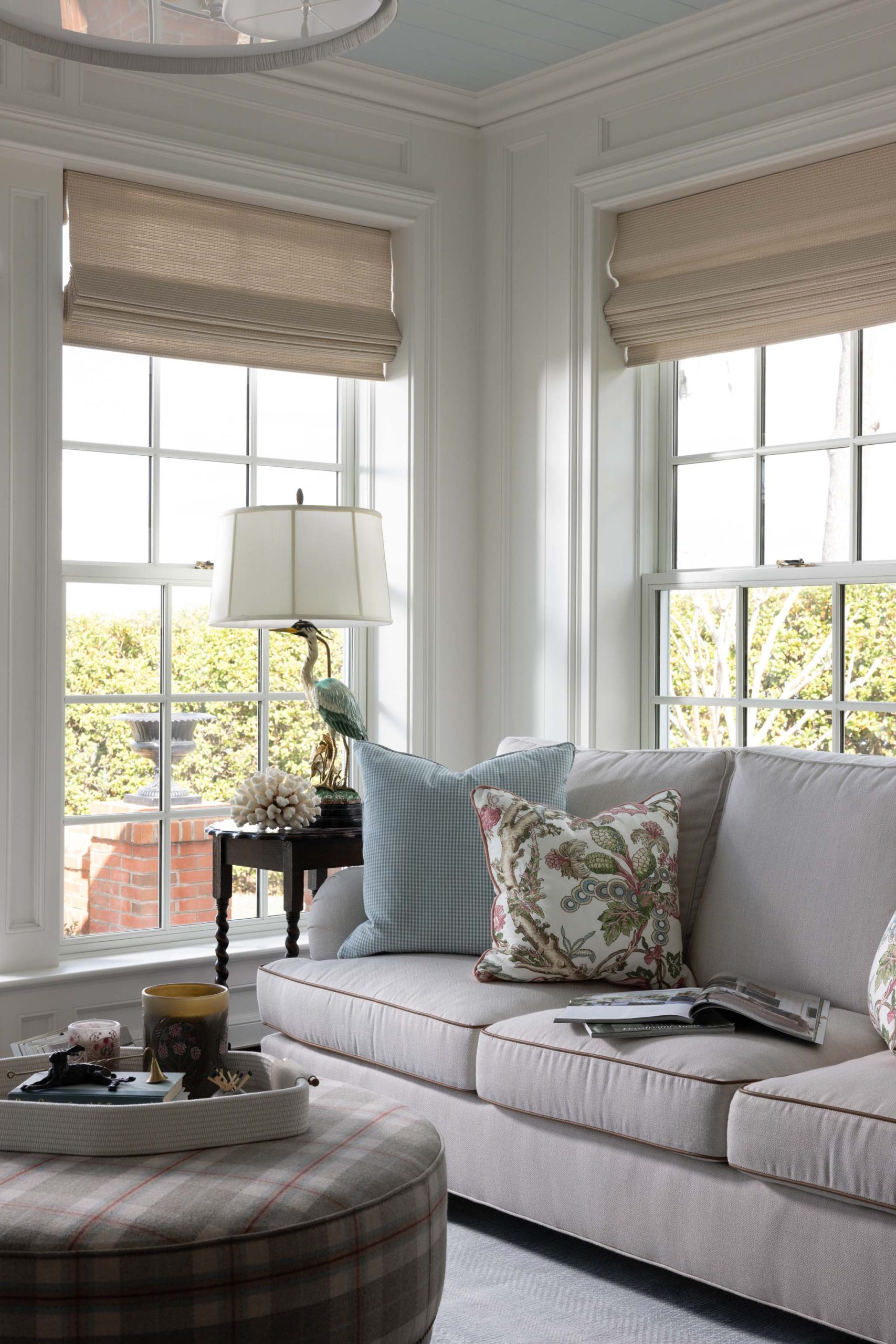 English country sunroom with custom upholstery, floral textiles and Roman shades
