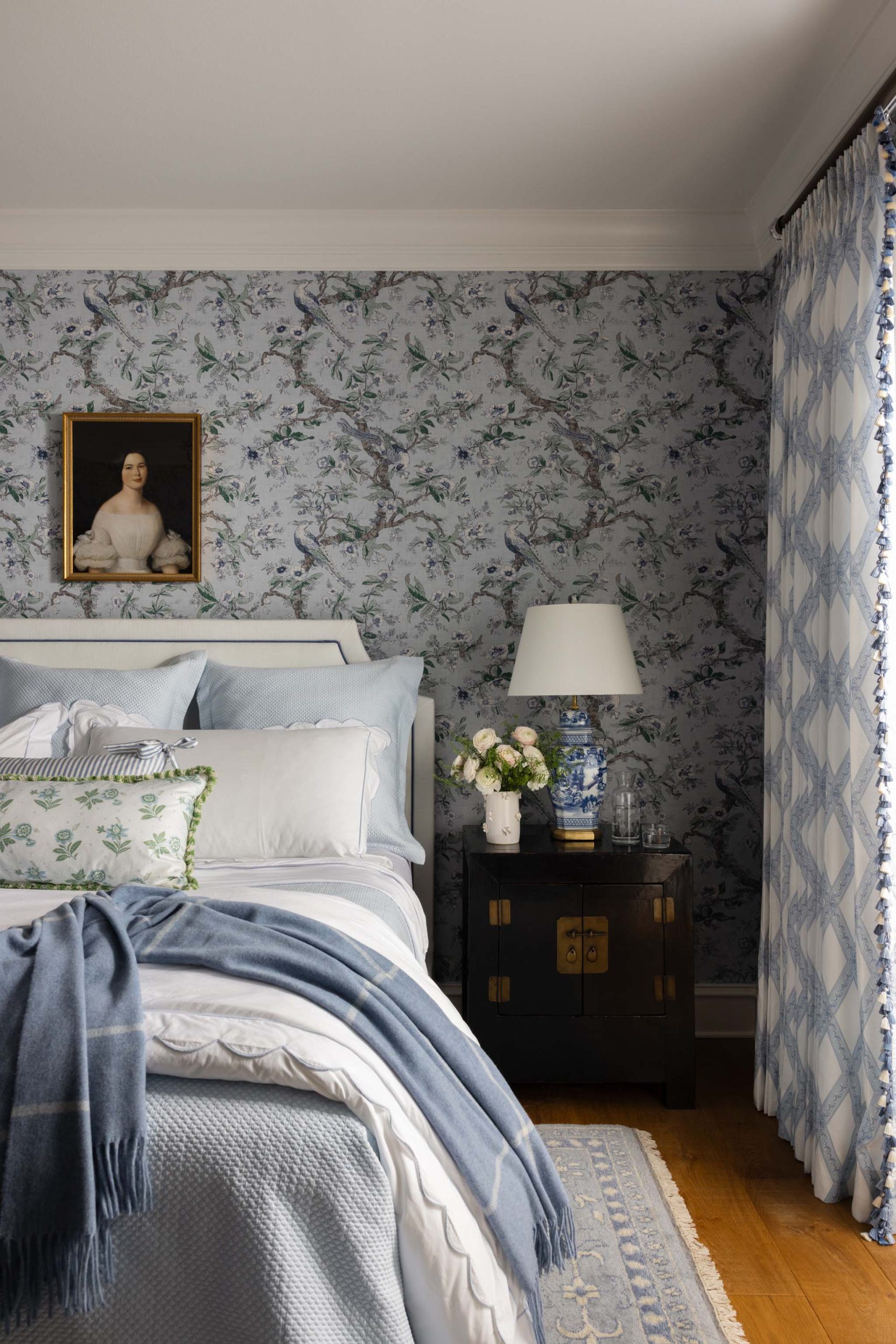 English primary bedroom with tailored drapery and antique Chinoiserie nightstand
