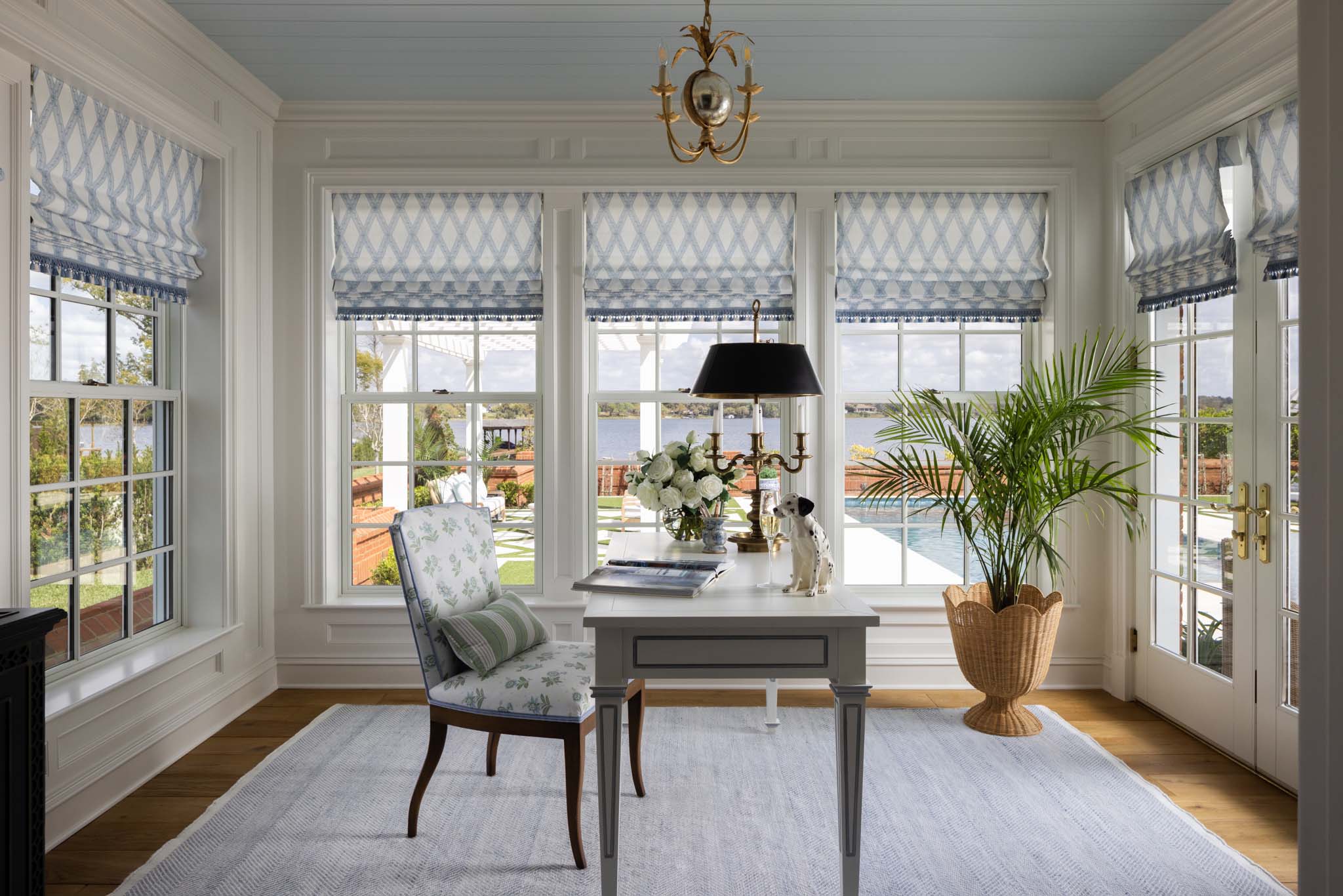 English country home office with custom Roman shades, blue tongue-and-groove ceiling and lake views