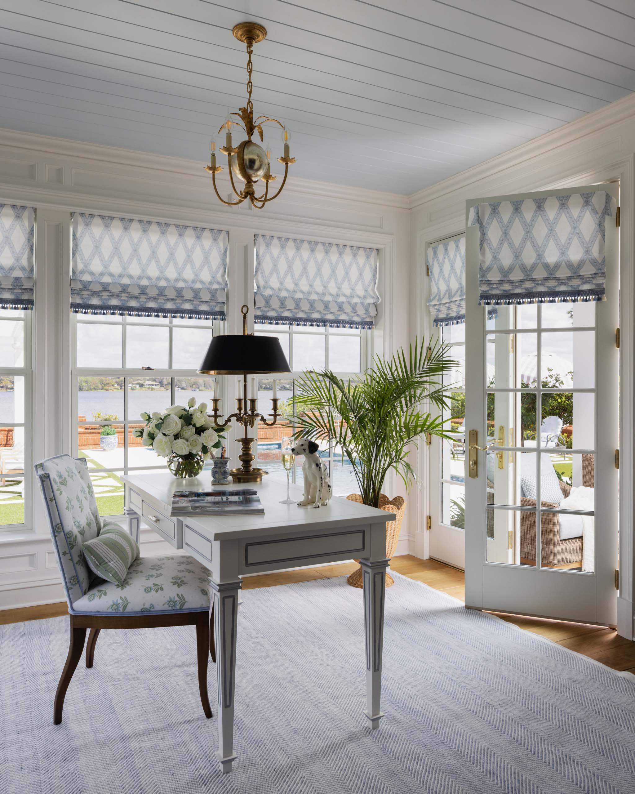 Blue and white English country home office with painted writing desk and upholstered chair