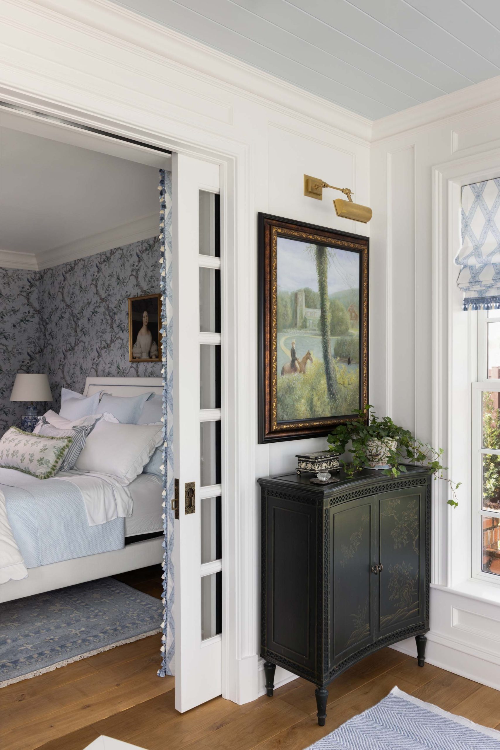 English home office with painted Chinoiserie cabinet and pocket doors