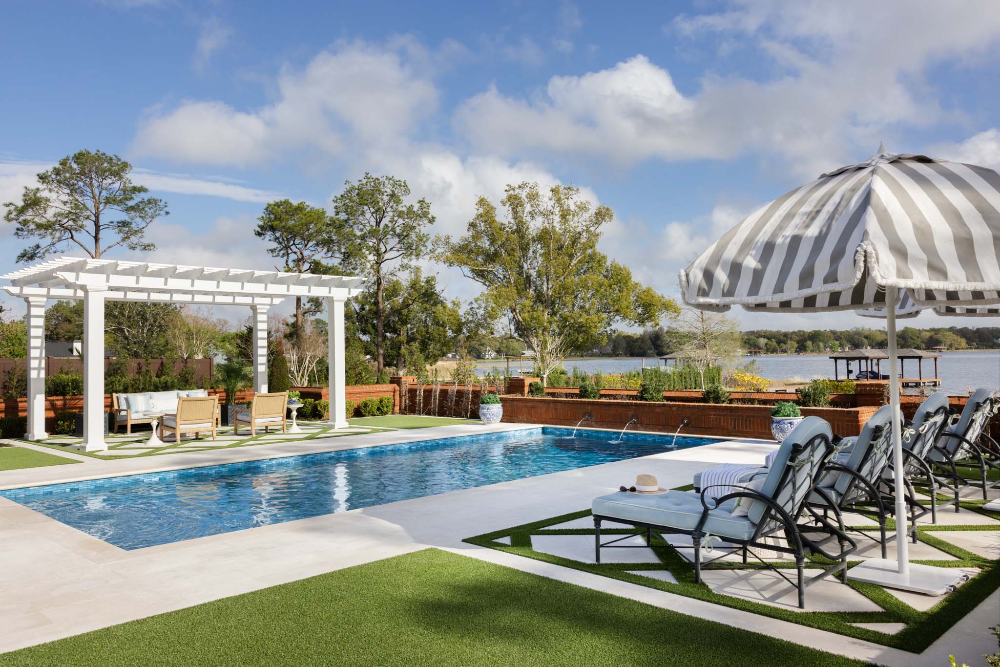 Luxury lakefront pool with pergola and outdoor seating