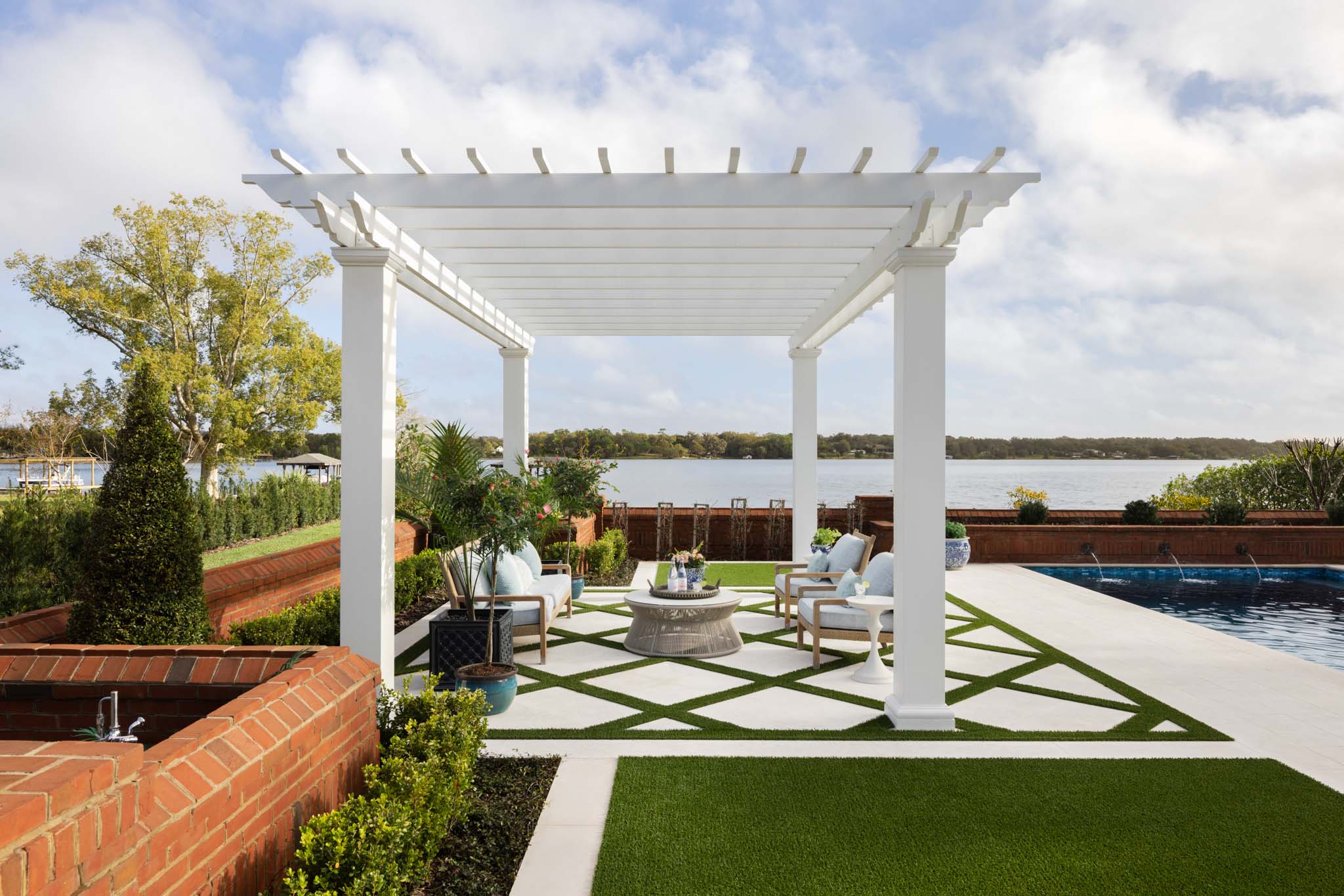 Poolside pergola with outdoor seating and lake views