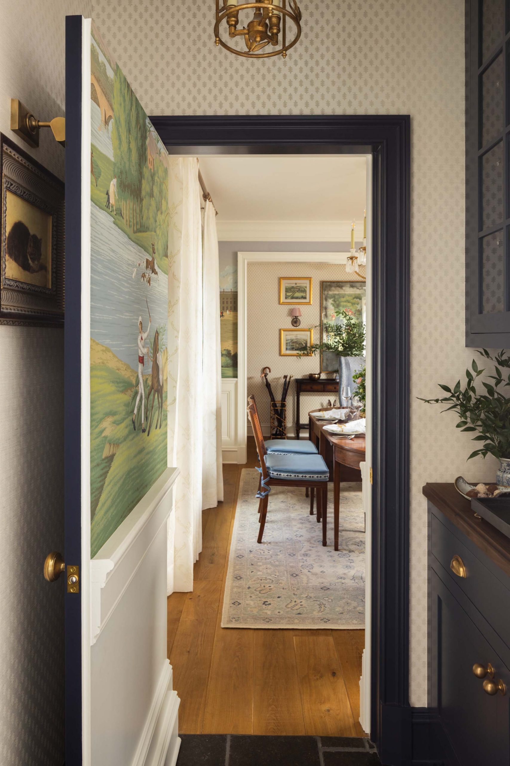 Hidden butler’s pantry door with hand-painted English pastoral mural